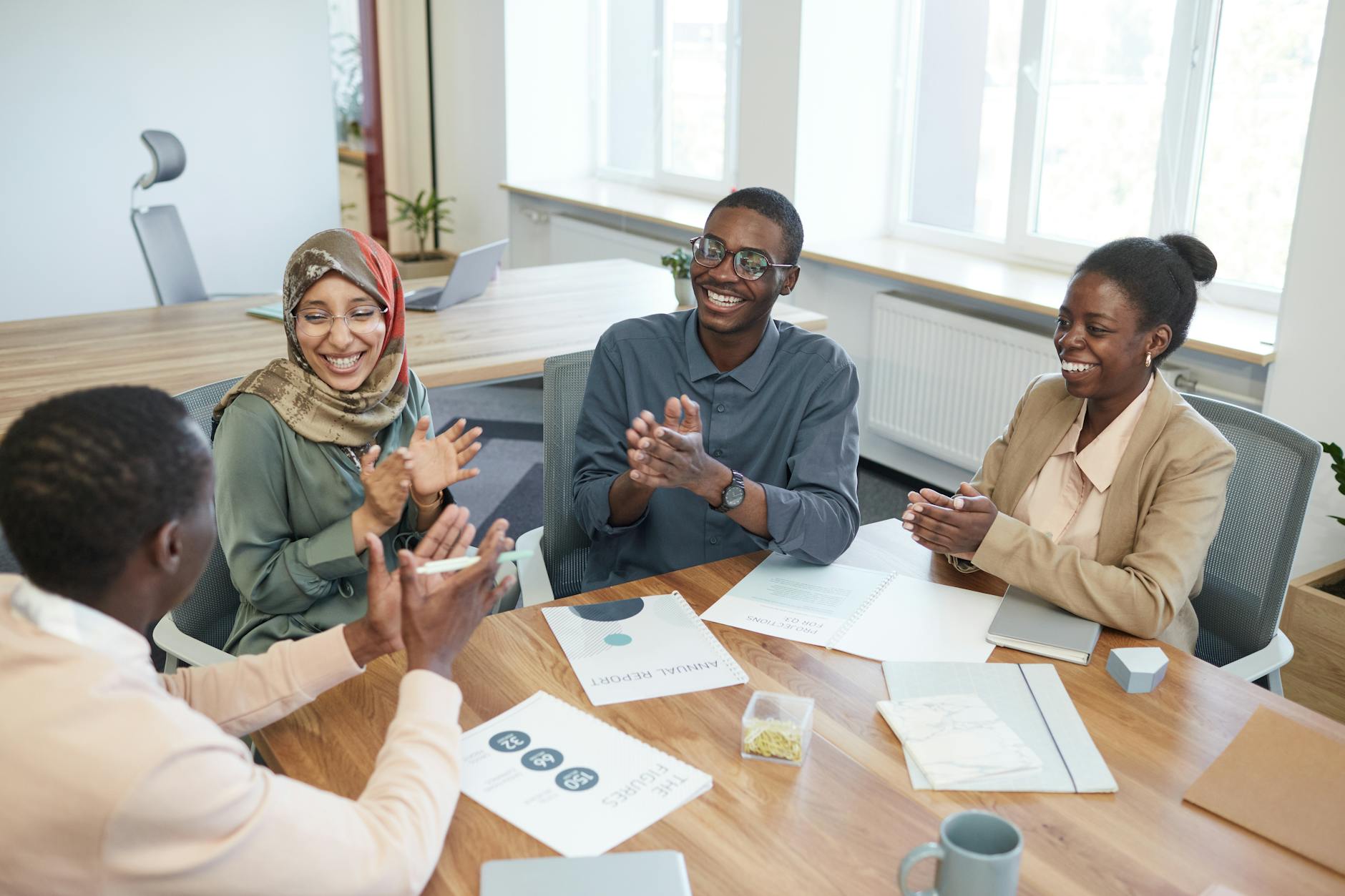https://www.pexels.com/photo/group-of-office-workers-holding-a-meeting-8554063/