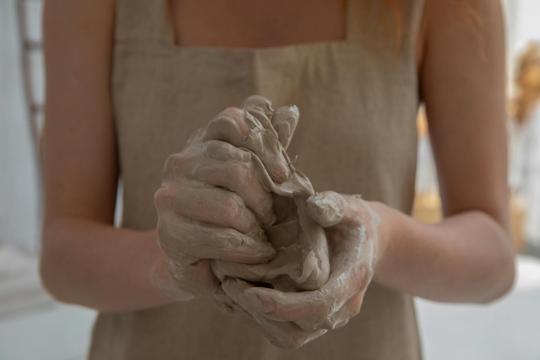 https://www.pexels.com/photo/crop-faceless-woman-kneading-clay-in-workshop-5302891/