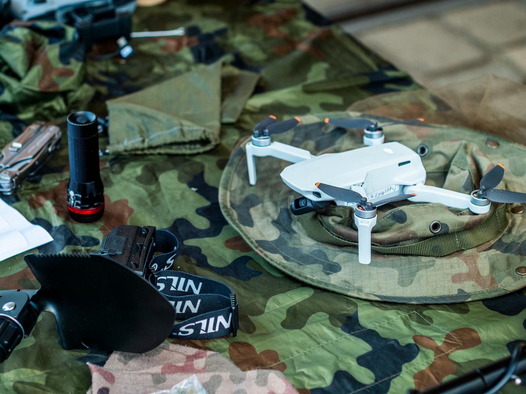 https://www.pexels.com/photo/compact-drone-on-camouflage-military-gear-32769115/