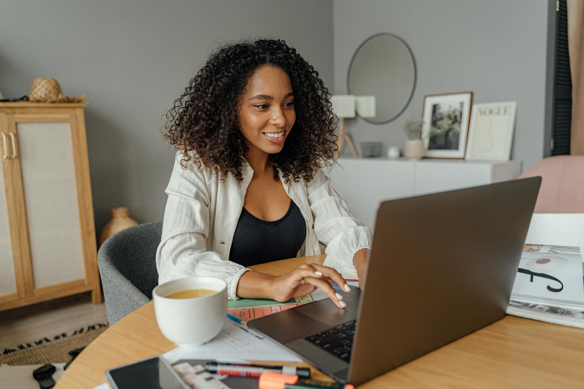 https://www.pexels.com/photo/woman-in-white-blazer-using-macbook-pro-on-brown-wooden-table-5244025/