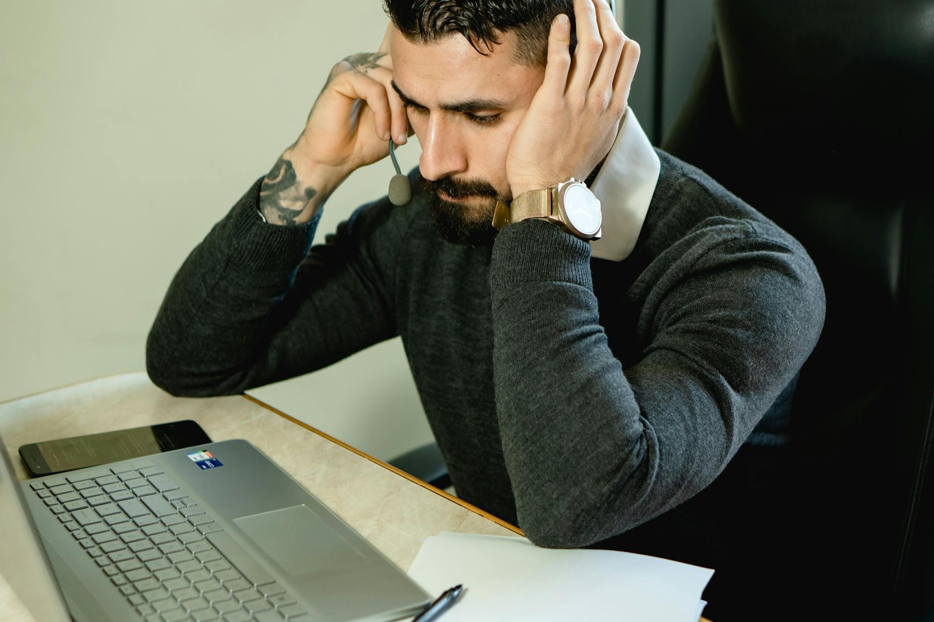 https://www.pexels.com/photo/man-with-a-headset-sitting-near-a-laptop-7504887/