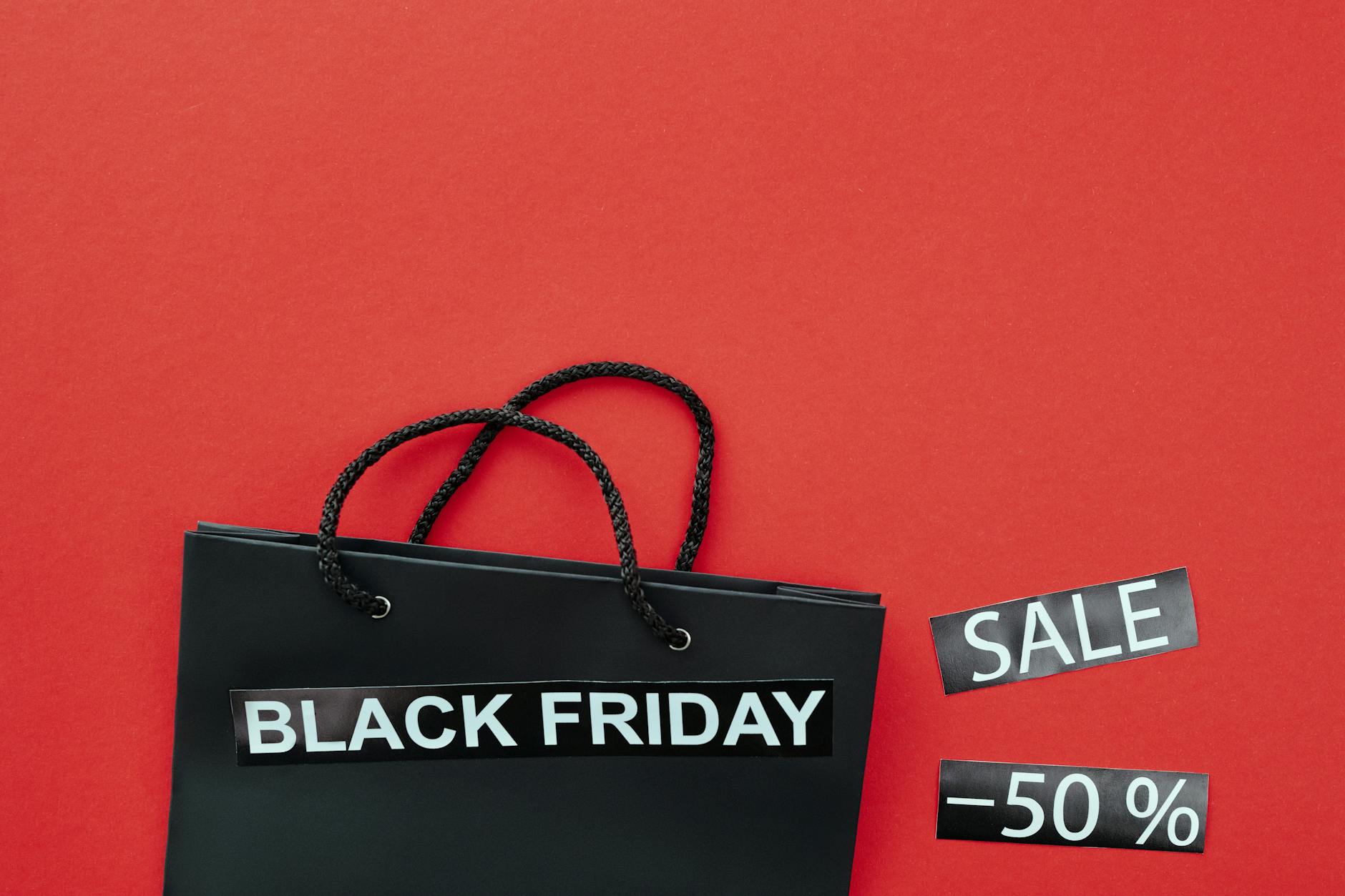 https://www.pexels.com/photo/close-up-shot-of-a-black-shopping-bag-beside-discount-tags-5872294/